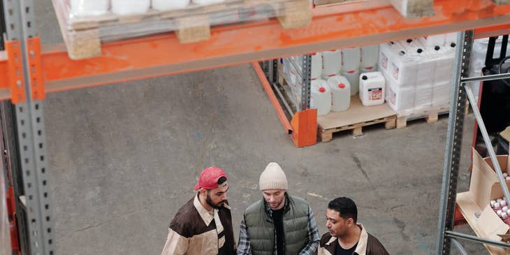 Warehouse operator with the warehouse workers checking if the merchandise that just arrives is complete