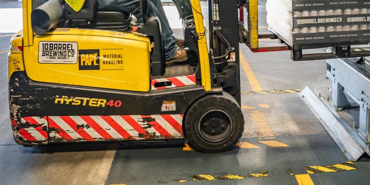 Warehouse worker using a forklift.