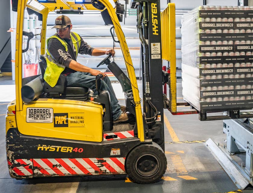 Warehouse worker using a forklift.