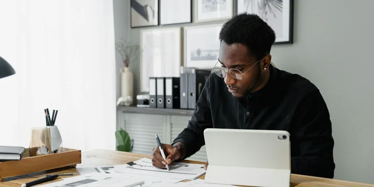 A wealth management associate working behind a desk.