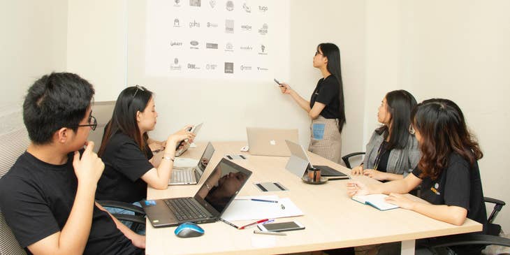 a web development manager discussing their company's future project with a team of web developers