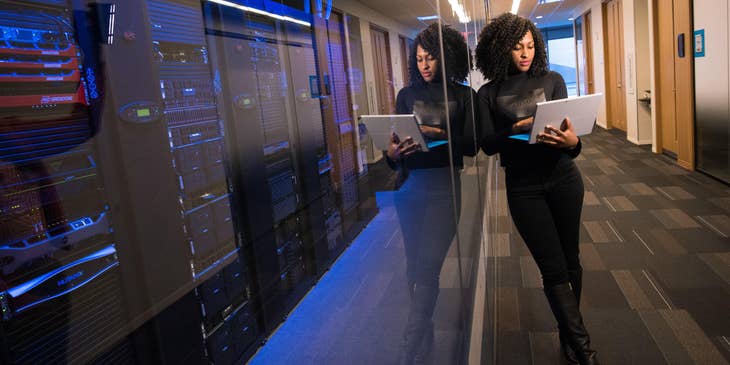 a web technician managing her client's web server system inside the server room