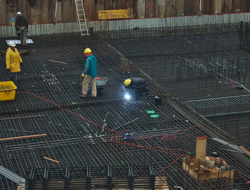 Welding inspector assessing welding work being done on a construction site