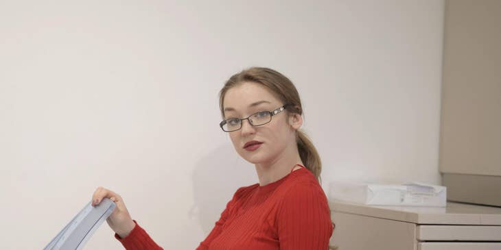Woman using a printer in an office.