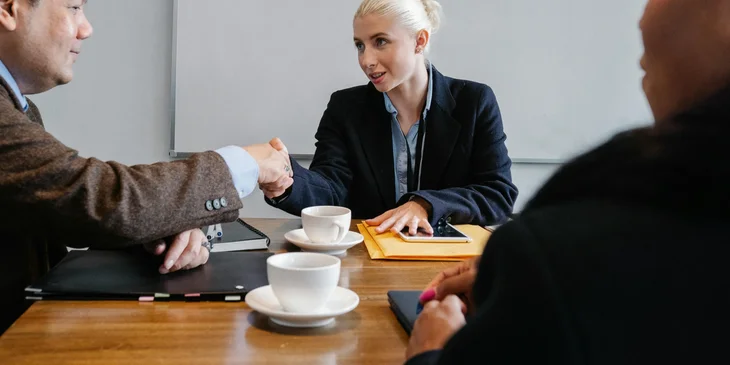 A wholesale account manager discussing in a meeting with a client.