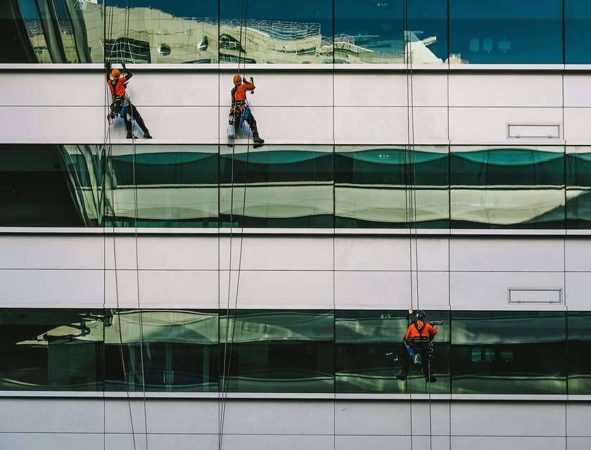 Window cleaning technicians working on a high building