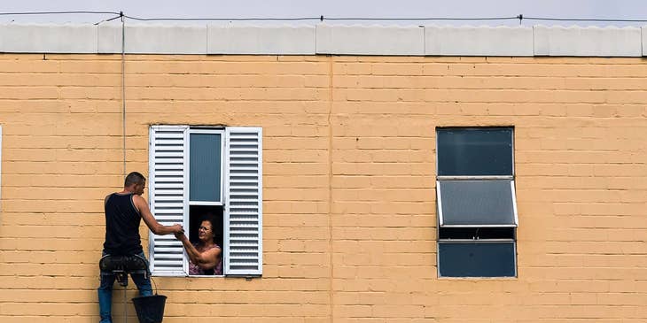 Window treatment installer fitting new shutters