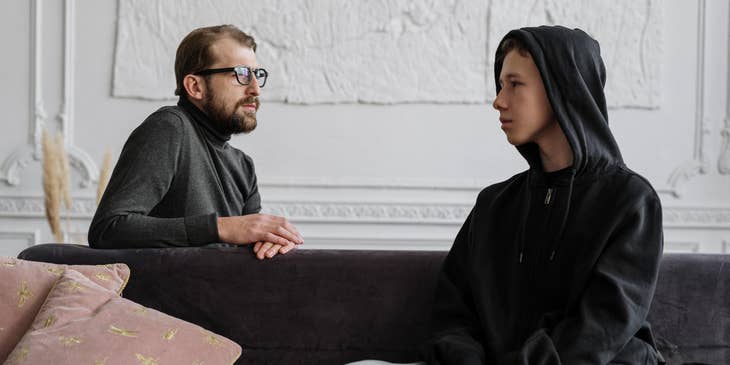Youth counselor talking closely to his young patient during their counseling session
