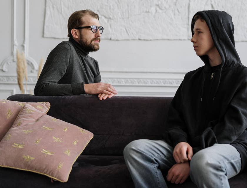 Youth counselor talking closely to his young patient during their counseling session